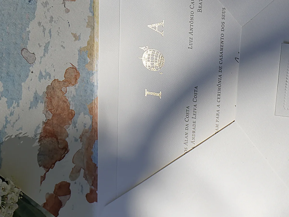 Printed wedding invitation with gold foil monogram, watercolor envelope liner